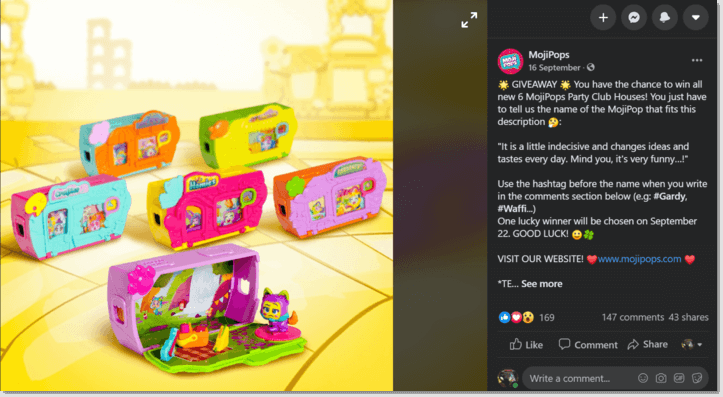 Screenshot of a Facebook post from toy brand MojiPops. The main image shows a set of 6 toys. The caption asks users to pick which figure is the answer to a riddle, and describe why they would like to win the set of 6 toys.