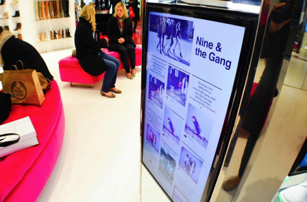Photo of a display screen in store, showing Instagram photos from customers.
