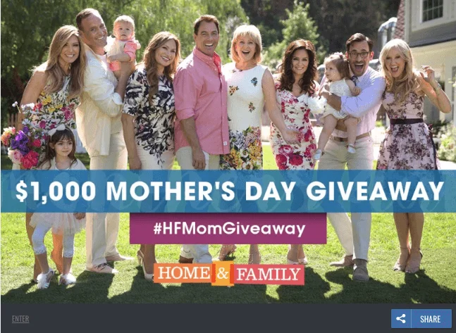 Banner announcing a Mother's Day video contest. The photo shows a large family posing for a photo in a garden. The text reads: "$1000 Mother's Day giveaway. #HFMomGiveaway Home & Family".